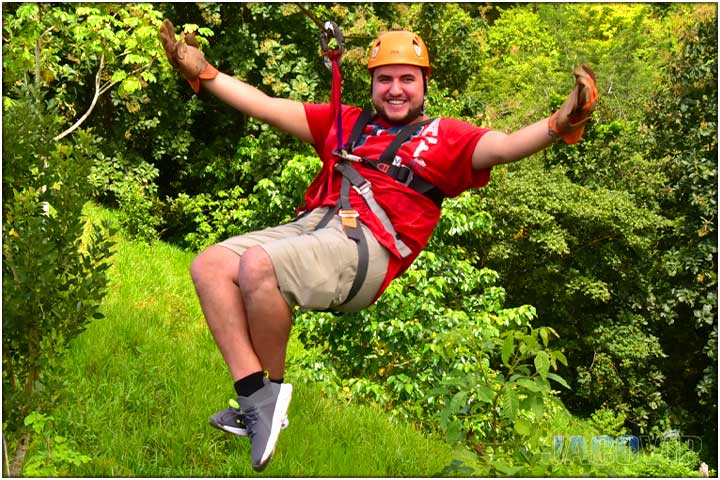 Guy with red shirt on a zip line tour