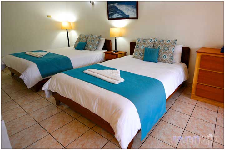 2 queen size beds ith blue accents pillows and bed runner