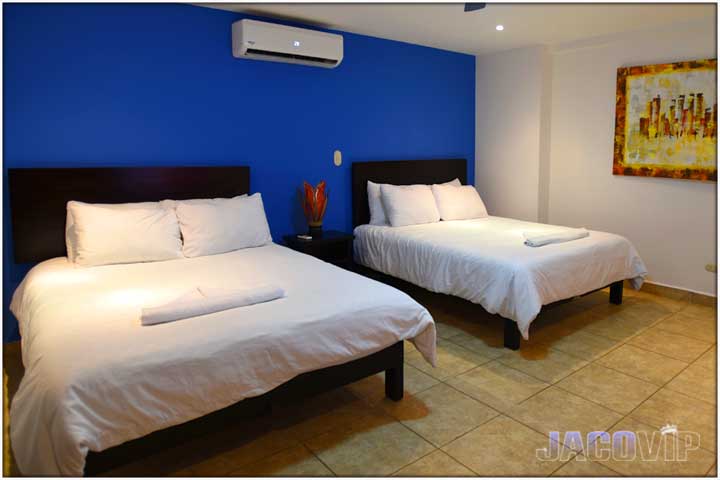 Two queen size beds and painting on the wall