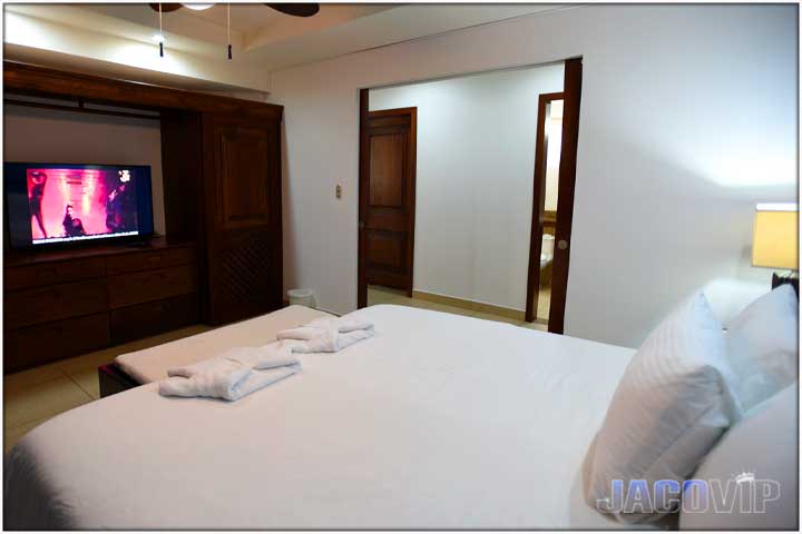 Entrance to bedroom number two with king bed and large TV
