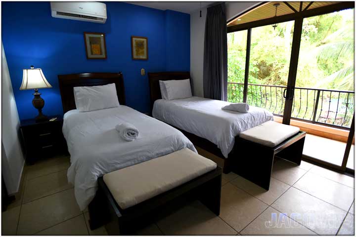 View of beds and balcony area next to bedroom