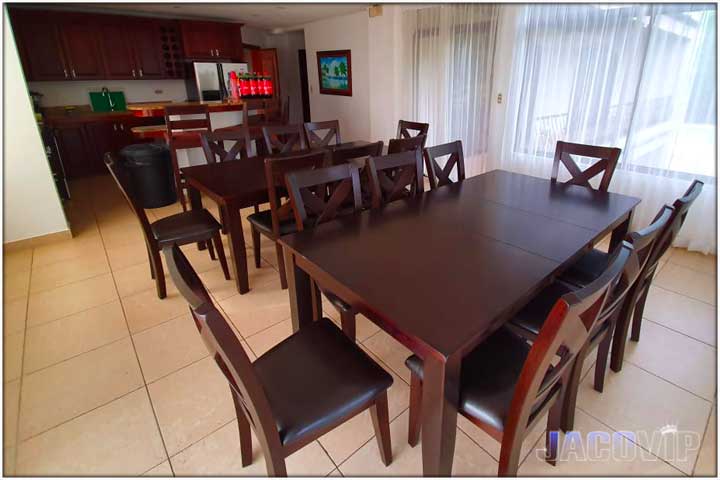 View of dining tables and kitchen cooking area