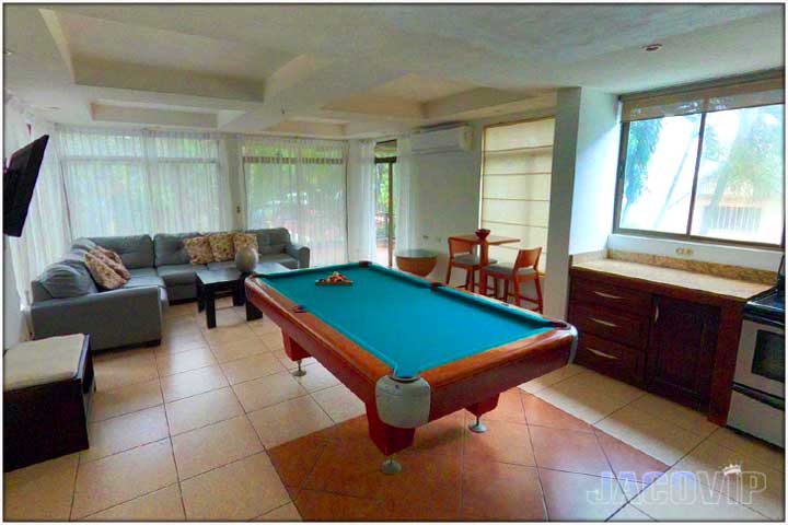 Pacific Palms living room with comfortable sofas and TV and pool table