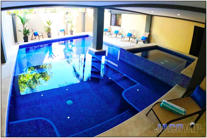 photo of pool and jacuzzi taken from underneath the balcony