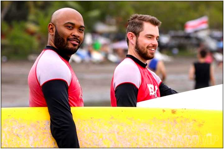 2 guys taking surf lessons