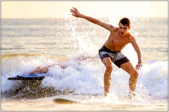 Guy on surfboard during lesson