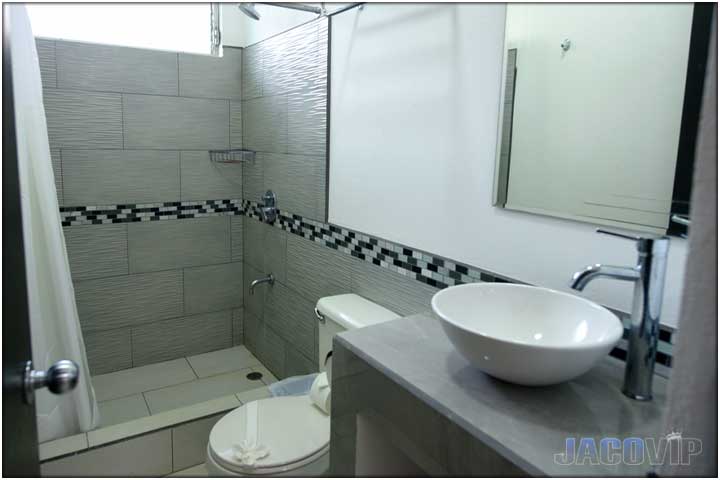 Bathroom with grey tiles and modern sink