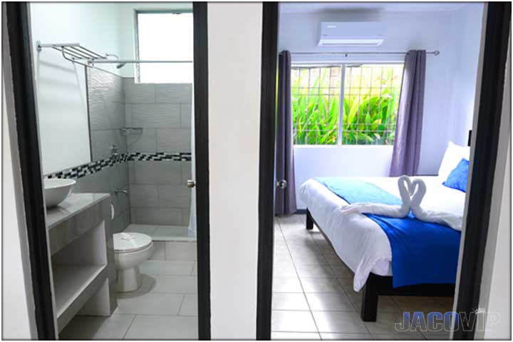 Split view of bedroom and bathroom doors open