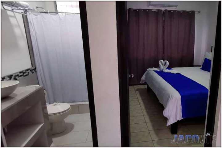 split view of bedroom and bathroom