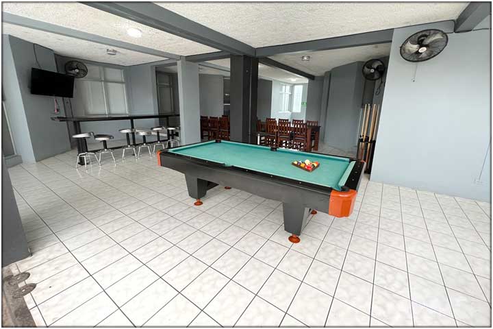 Pool table with blue green carpet