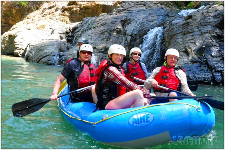 People on blue raft during calm river