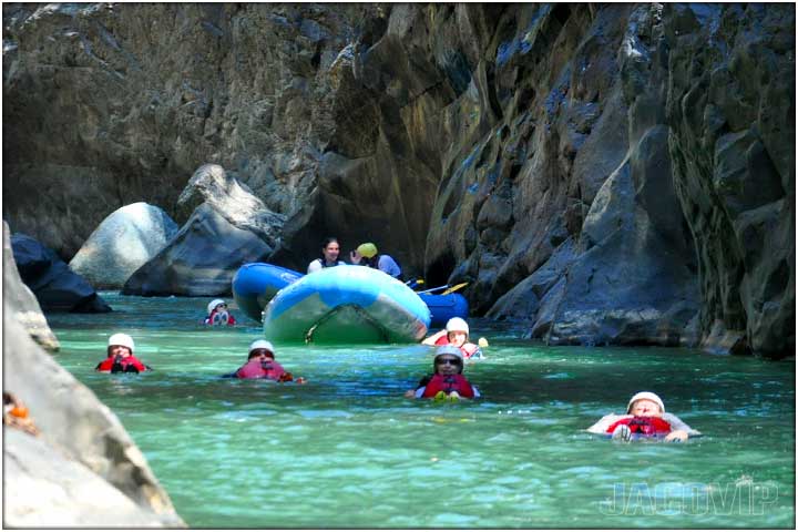 People swimming in calm river water