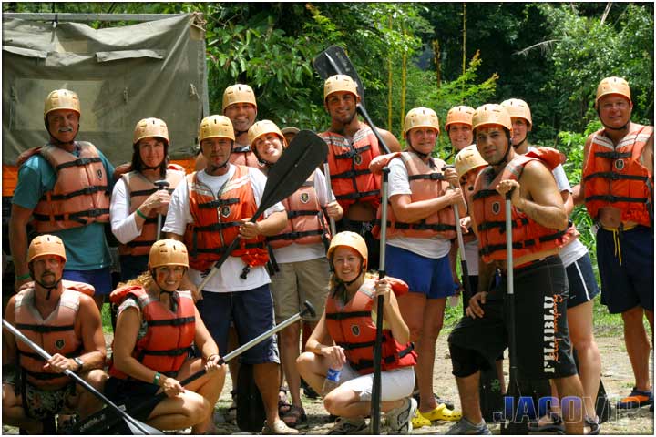 Group of men and women posing for rafting tour